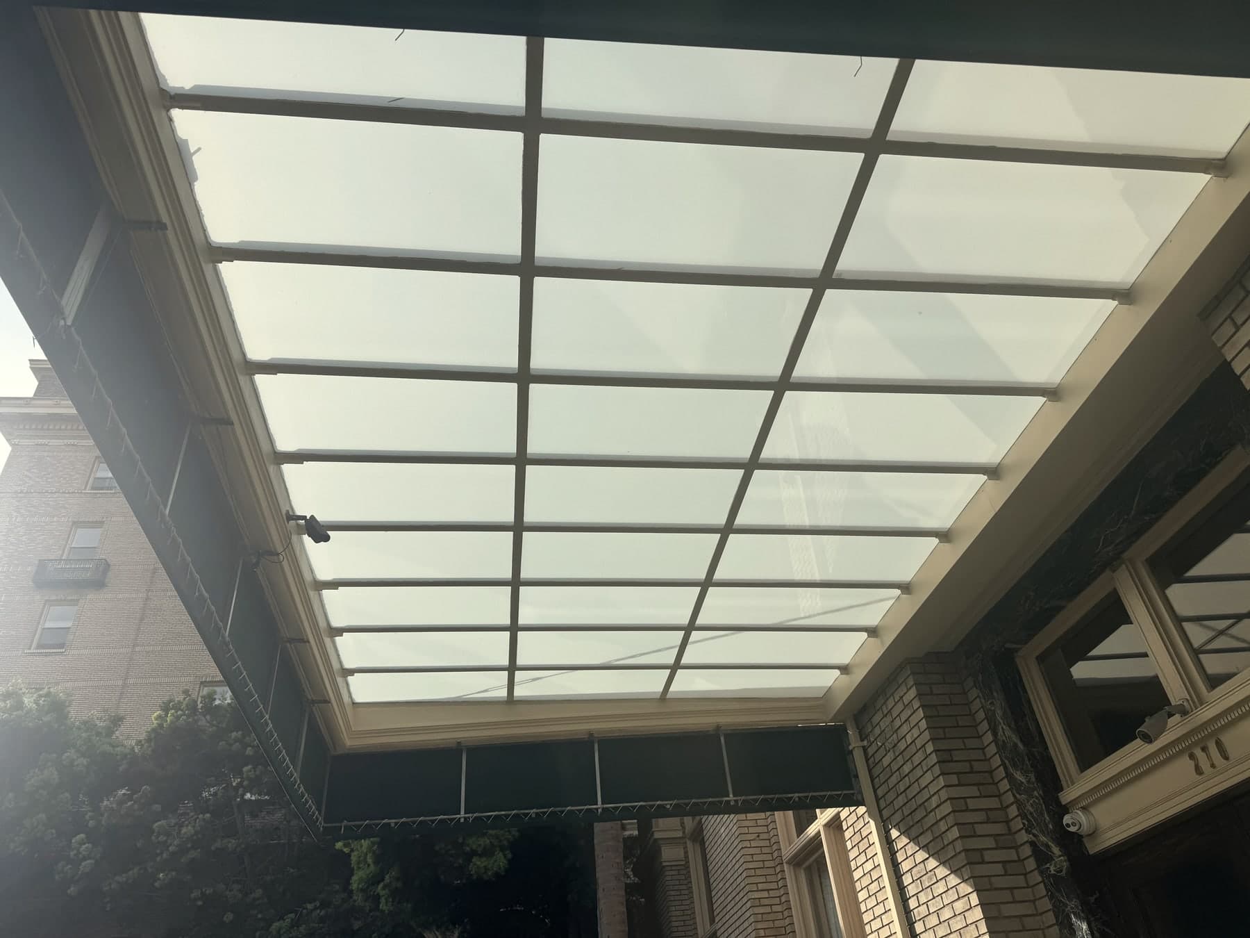 Translucent patio cover panels with a metal support grid.